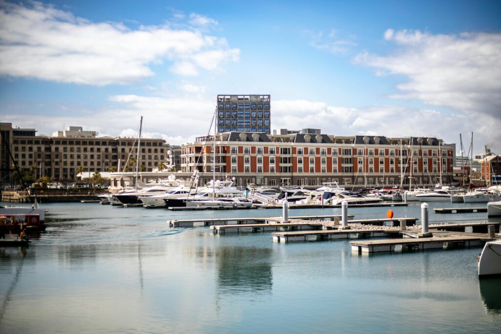 pexels-photo-28441232-28441232 Luxury waterfront hotel and marina with yachts in Cape Town, South Africa.
